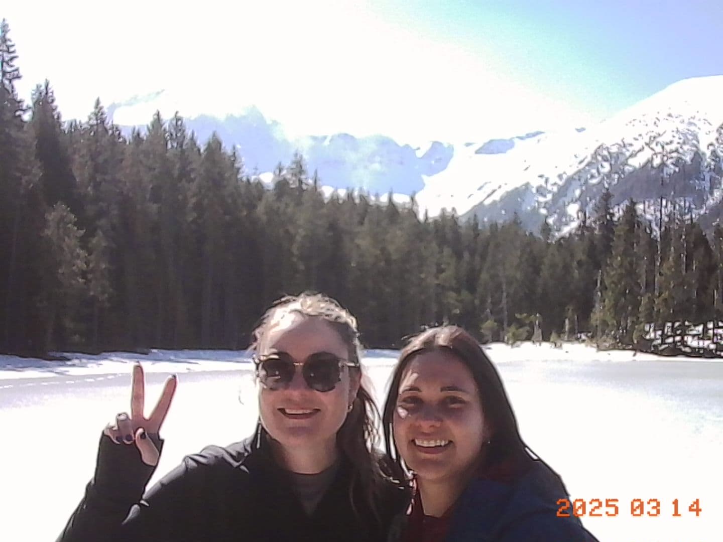 Jacqui and Ellie smiling by the frozen lake