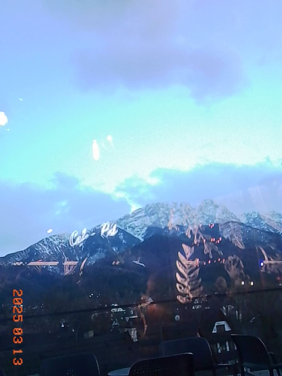 Snow-capped mountain peaks above a forested ridge