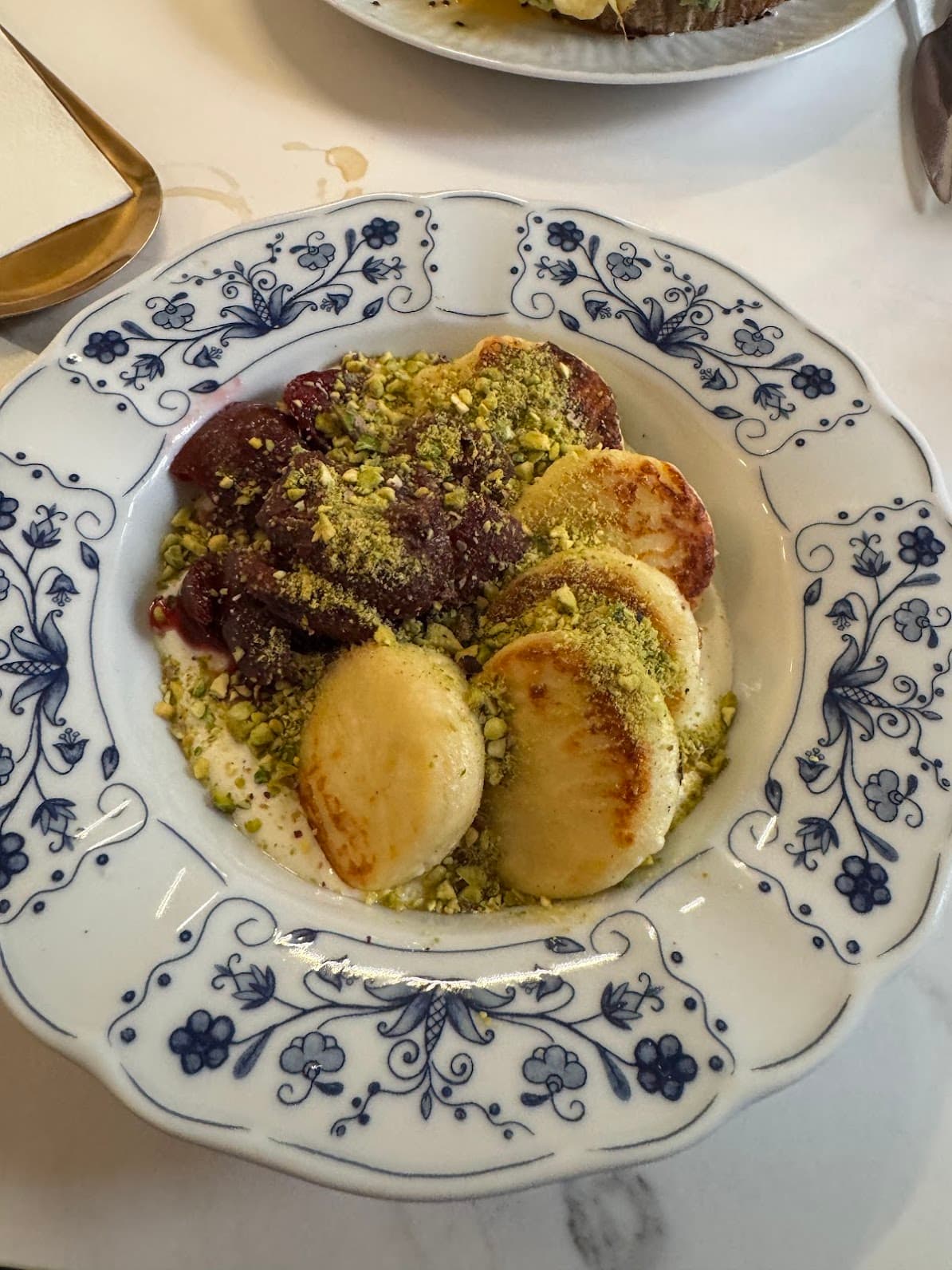 Breakfast plate with pancakes and fruit in a Kraków café