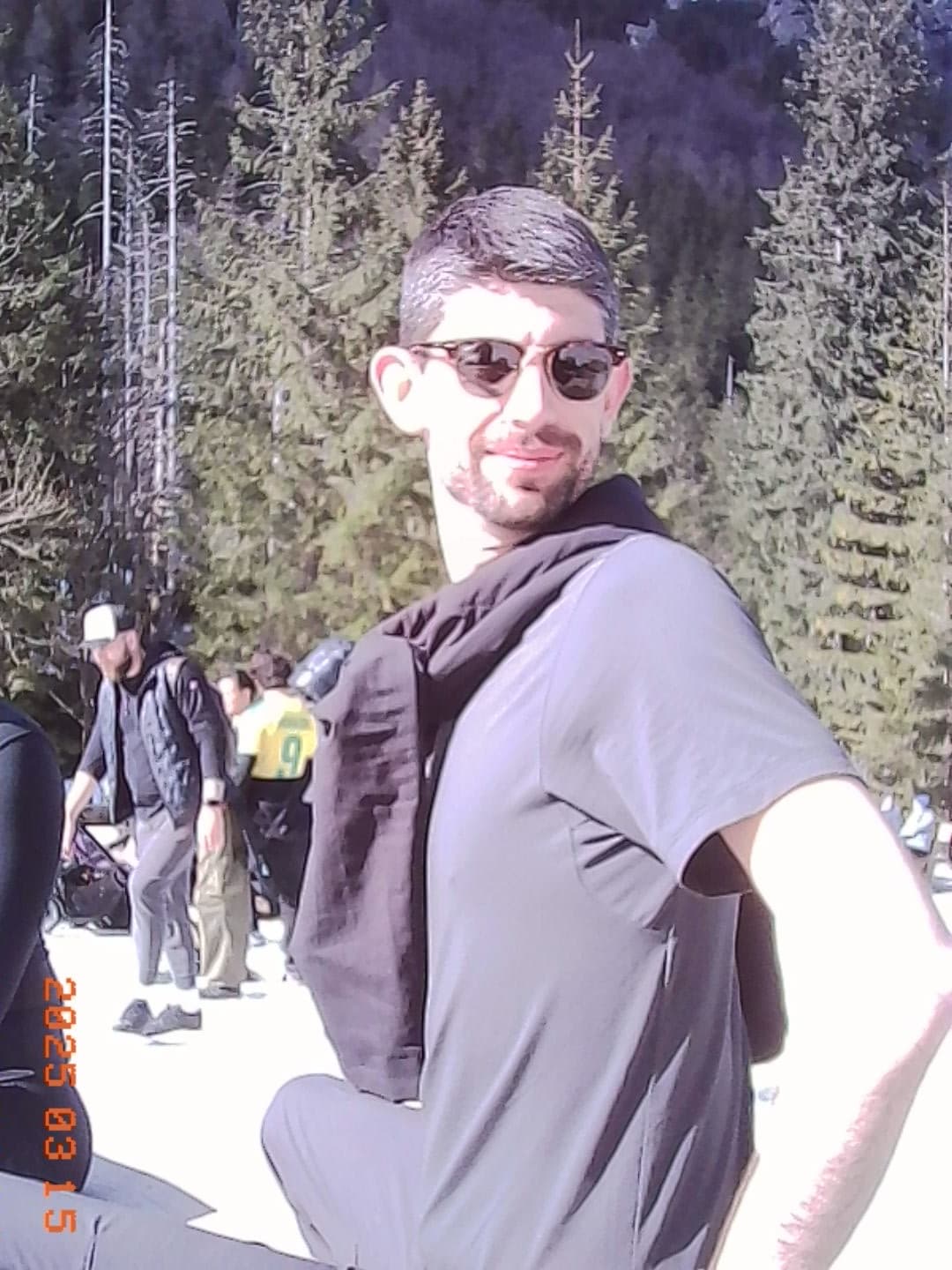 Zac posing on the snowy mountain trail